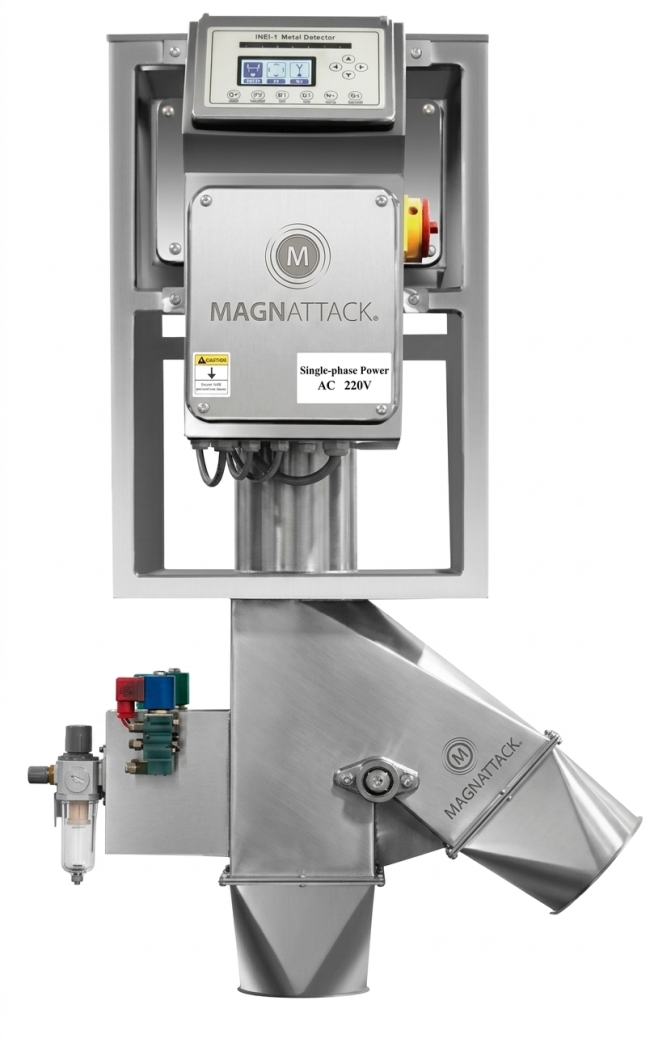 Industrial Magnattack metal detector on a stainless steel frame with a control panel and downstream chute, for bulk material safety.